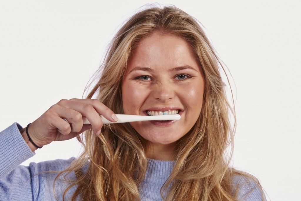 Young woman loose hair toothbrush portrait